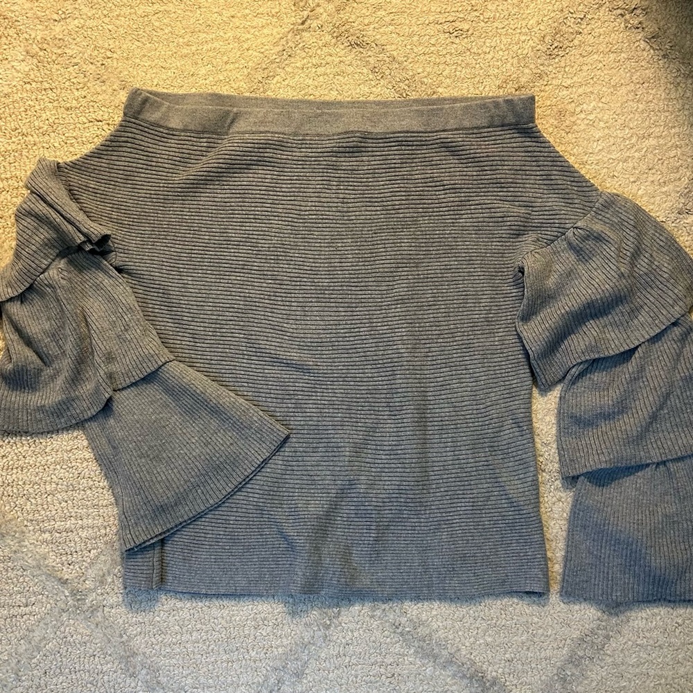Grey off the shoulder sweater with ruffle bell sleeves.